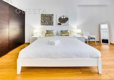 a bedroom with a white bed and two chairs at Jumeirah Beach Residence - Rimal 3, Dubai Marina in Dubai