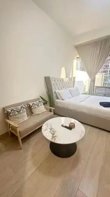 a living room with a couch and a coffee table at Luxury Studio with big balcony Azizi Riviera Meydan in Dubai