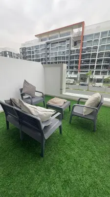 three chairs sitting on top of a roof at Luxury Studio with big balcony Azizi Riviera Meydan in Dubai