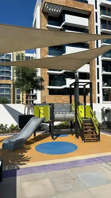a playground with a slide in front of a building at Luxury Studio with big balcony Azizi Riviera Meydan in Dubai