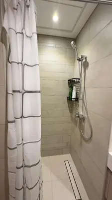a bathroom with a shower with a shower curtain at Luxury Studio with big balcony Azizi Riviera Meydan in Dubai
