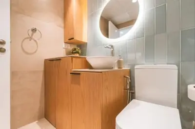 a bathroom with a toilet and a sink and a mirror at Cozy Chic Studio with Balcony The Greens Dubai in Dubai