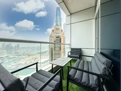 a balcony with chairs and a view of the city at SettlerHomes- Breathtaking 2BR Marina High-Floor in Dubai