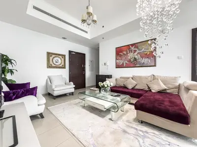 a living room with a couch and a glass table at SettlerHomes- Breathtaking 2BR Marina High-Floor in Dubai