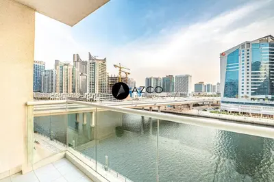 a view of a city from the balcony of a building at Panoramic 2BR - 3 Balconies & Canal Views - Damac Maison Prive by AZCO Holiday Homes in Dubai