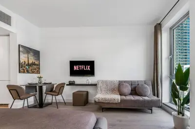 a living room with a couch and a table at Luxueux Studio, Top emplacement in Dubai