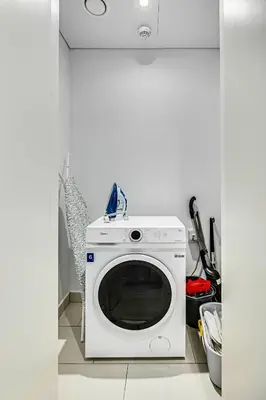a white washing machine sitting in a kitchen at Stylish sea view from new 2BD La Vie in Dubai
