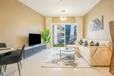 a living room with a couch and a tv at Specious pool view One Bed room in Dubai