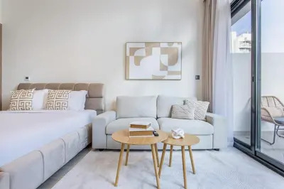 a living room with a couch and a table at Artist Heaven Studio! Riviera 35! 10 min Downtown in Dubai