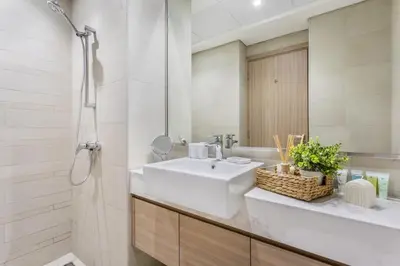 a bathroom with a white sink and a mirror at Artist Heaven Studio! Riviera 35! 10 min Downtown in Dubai