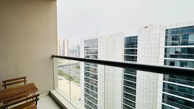 a balcony with a bench and a view of a building at Upscale Studio Apartment Palm View with Big Balcony Free Parking by Belvilla in Dubai