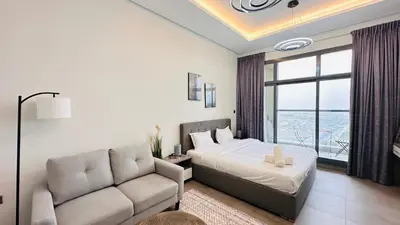 a bedroom with a bed and a couch at Upscale Studio Apartment Palm View with Big Balcony Free Parking by Belvilla in Dubai