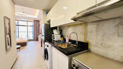 a kitchen with a sink and a counter top at Upscale Studio Apartment Palm View with Big Balcony Free Parking by Belvilla in Dubai