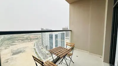 a balcony with two chairs and a view of a city at Upscale Studio Apartment Palm View with Big Balcony Free Parking by Belvilla in Dubai