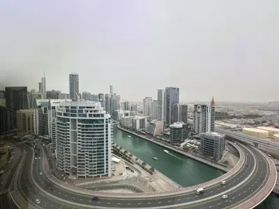 a view of a city with a river and buildings at SettlerHomes - Chic Jumeirah Gate with Beach Access in Dubai