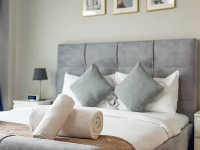 a bedroom with a bed with a rolled up towel at SettlerHomes - Chic Jumeirah Gate with Beach Access in Dubai