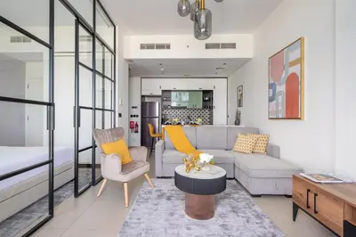 a living room with a couch and a table at Frank Porter - Socio Tower 2 in Dubai