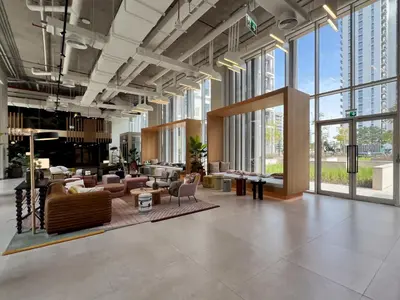 a lobby with couches and chairs in a building at Frank Porter - Socio Tower 2 in Dubai