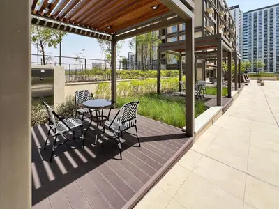 a patio with chairs and a table on a building at Frank Porter - Socio Tower 2 in Dubai