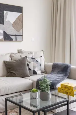 a living room with a couch and a glass table at Frank Porter - 1 Residences in Dubai