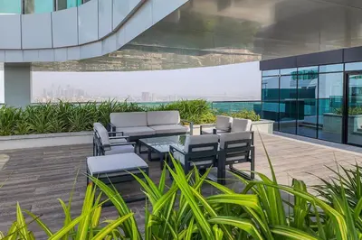 a patio with chairs and a table on a building at Frank Porter - 1 Residences in Dubai