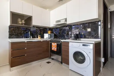 a kitchen with a washer and a washing machine at Frank Porter - Jwelz By Danube in Dubai