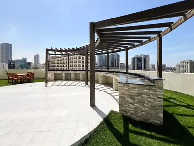 a patio with awning on top of a building at Frank Porter - Jwelz By Danube in Dubai