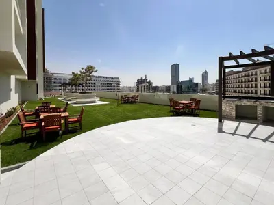 a patio with tables and chairs on top of a building at Frank Porter - Jwelz By Danube in Dubai
