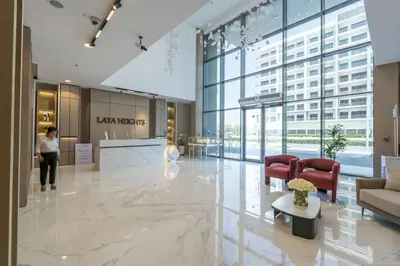 a lobby of a building with a woman standing in it at Brand New Building * Czechin * Studio City in Dubai