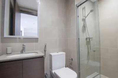 a bathroom with a shower and a toilet and a sink at Stylish 2 bedroom apartment in Sobha Hartland in Dubai