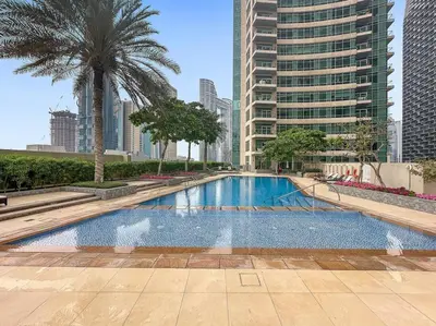 a large swimming pool in a city with tall buildings at FIRST CLASS 2BR Stunning Fountain View in Dubai