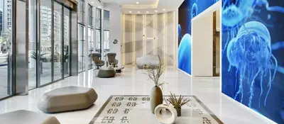 a lobby with a dermatologist appointment room with chairs at Panoramic LUX Apartment with Burj Khalifa View in Dubai