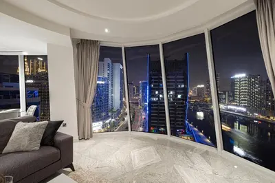 a living room with a view of a city at night at Panoramic LUX Apartment with Burj Khalifa View in Dubai