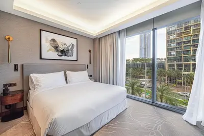 a bedroom with a large bed and a large window at Luxury 1BR The Address Opera, Downtown Dubai in Dubai