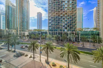 a city street with palm trees and tall buildings at Luxury 1BR The Address Opera, Downtown Dubai in Dubai