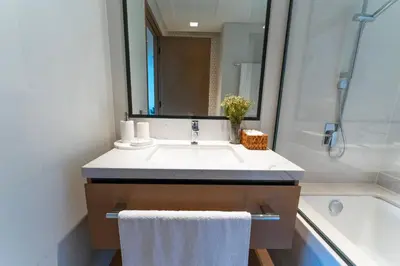 a bathroom with a sink and a bath tub at The Palace 405 I Luxury 2BD I Dubai Creek Harbour in Dubai