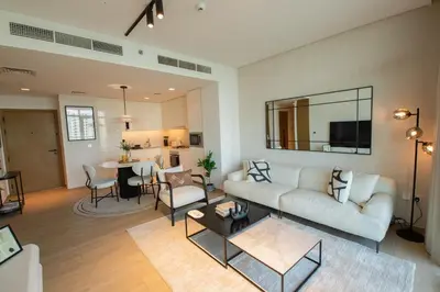 a living room with a couch and a table at The Palace 405 I Luxury 2BD I Dubai Creek Harbour in Dubai