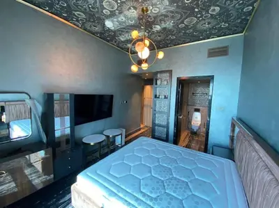 a bedroom with a bed and a chandelier at Luxurious 2BR in MBL JLT Brand New in Dubai
