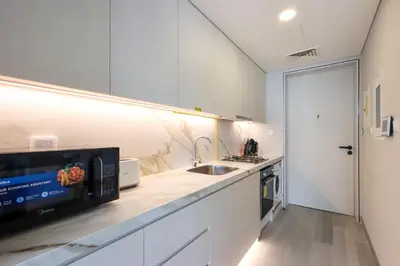 a kitchen with a sink and a microwave at Livbnb - Sea and Marina View, Steps to Marina Walk in Dubai