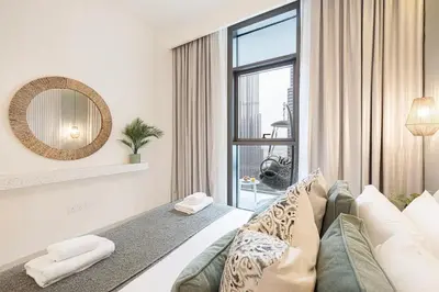 a bedroom with a bed and a large window at Burj Crown - New Sky High, Near Burj Khalifa, Boulevard View, Opposite Dubai Mall in Dubai