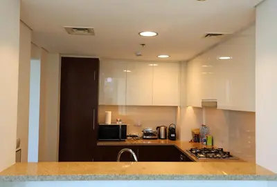 a kitchen with a sink and a stove top oven at Elegant 1BR Oasis Burj Vista Steps to Burj Khalifa - 11AB08 in Dubai