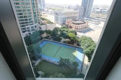 a view of a tennis court from a window at Elegant 1BR Oasis Burj Vista Steps to Burj Khalifa - 11AB08 in Dubai