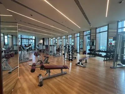 a gym with cardio equipment in a large building at Elegant 1BR Oasis Burj Vista Steps to Burj Khalifa - 11AB08 in Dubai
