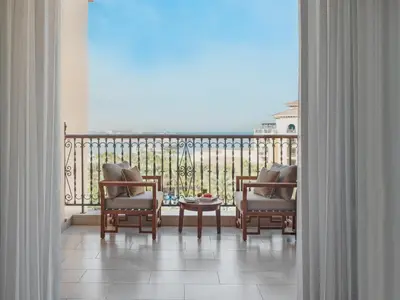 a balcony with two chairs and a table on a balcony at Four Seasons Resort Dubai at Jumeirah Beach in Dubai