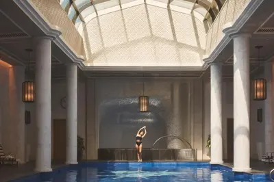 a woman standing in the middle of a swimming pool at Four Seasons Resort Dubai at Jumeirah Beach in Dubai
