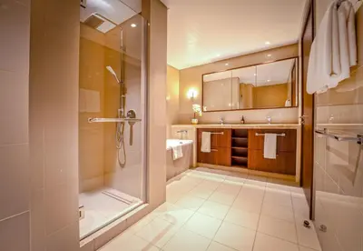 a bathroom with a shower and a sink and a shower at EasyGo - Upgraded 2BDR in BLVD Point with Burj Khalifa View in Dubai