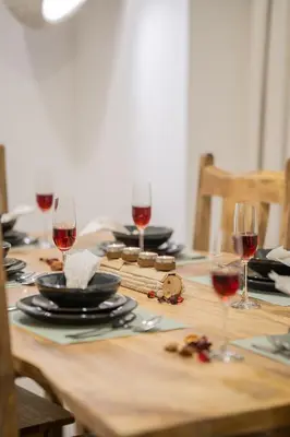 a wooden table with glasses of red wine on it at VIBES by Beds and Company - 51st Floor, Full Sea View in Dubai