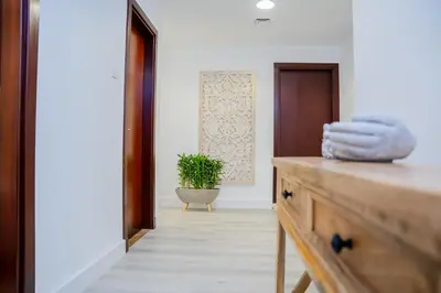 a bathroom with a wooden dresser with towels on it at VIBES by Beds and Company - 51st Floor, Full Sea View in Dubai