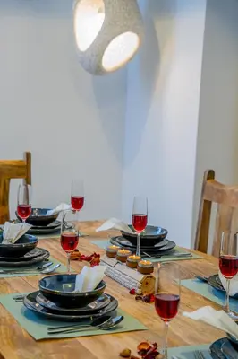 a table with glasses of red wine on it at VIBES by Beds and Company - 51st Floor, Full Sea View in Dubai