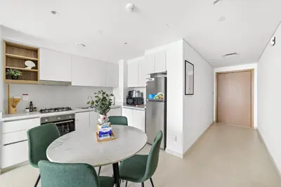 a kitchen and dining room with a table and chairs at Silkhaus Ultra Luxury 1BDR in New Tower of Downtown in Dubai
